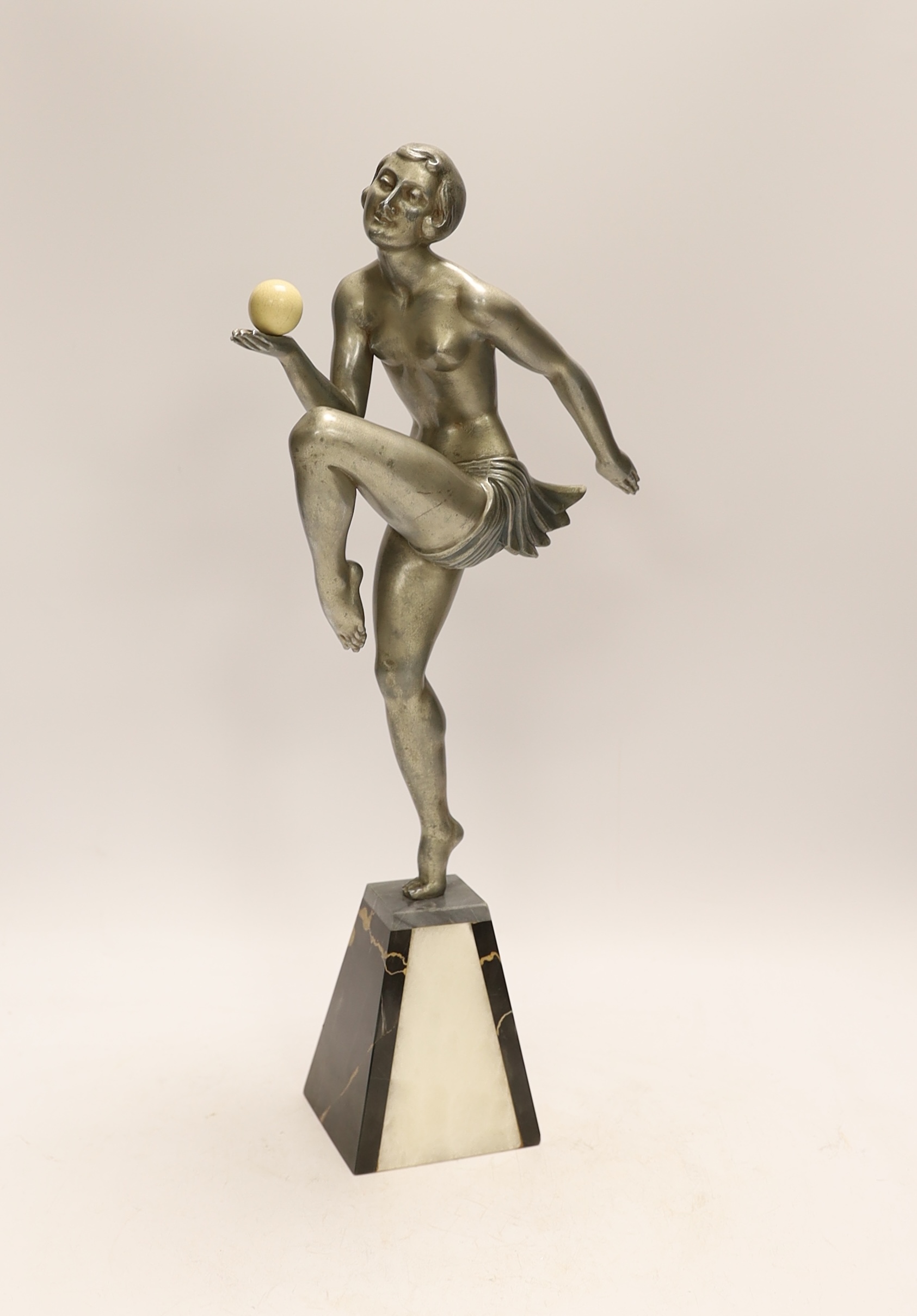 An Art Deco spelter and marble model of a dancing lady with ball, 44cm. Condition - good